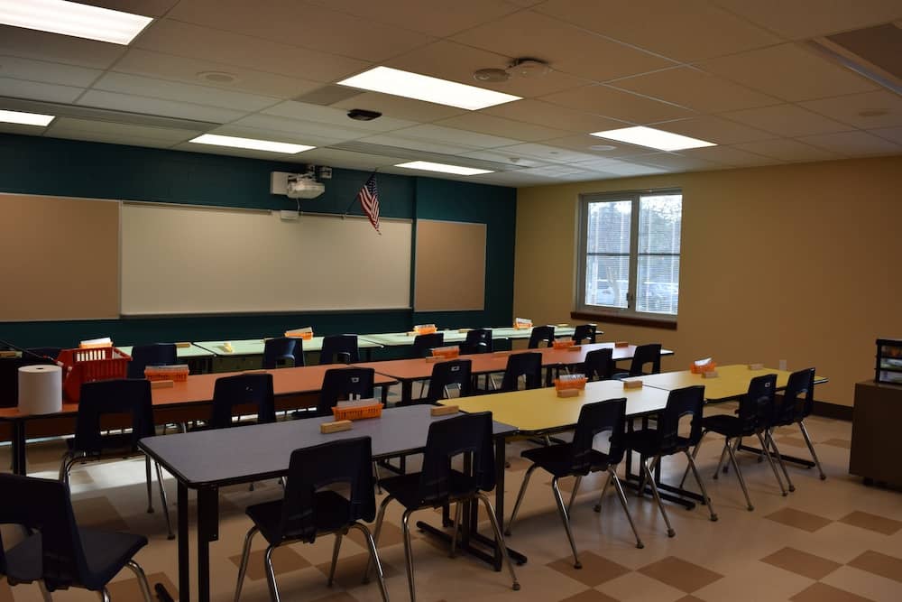 Streetsboro Elementary School Classroom lined with tables and chairs facing the front of the room with an projector and whiteboard