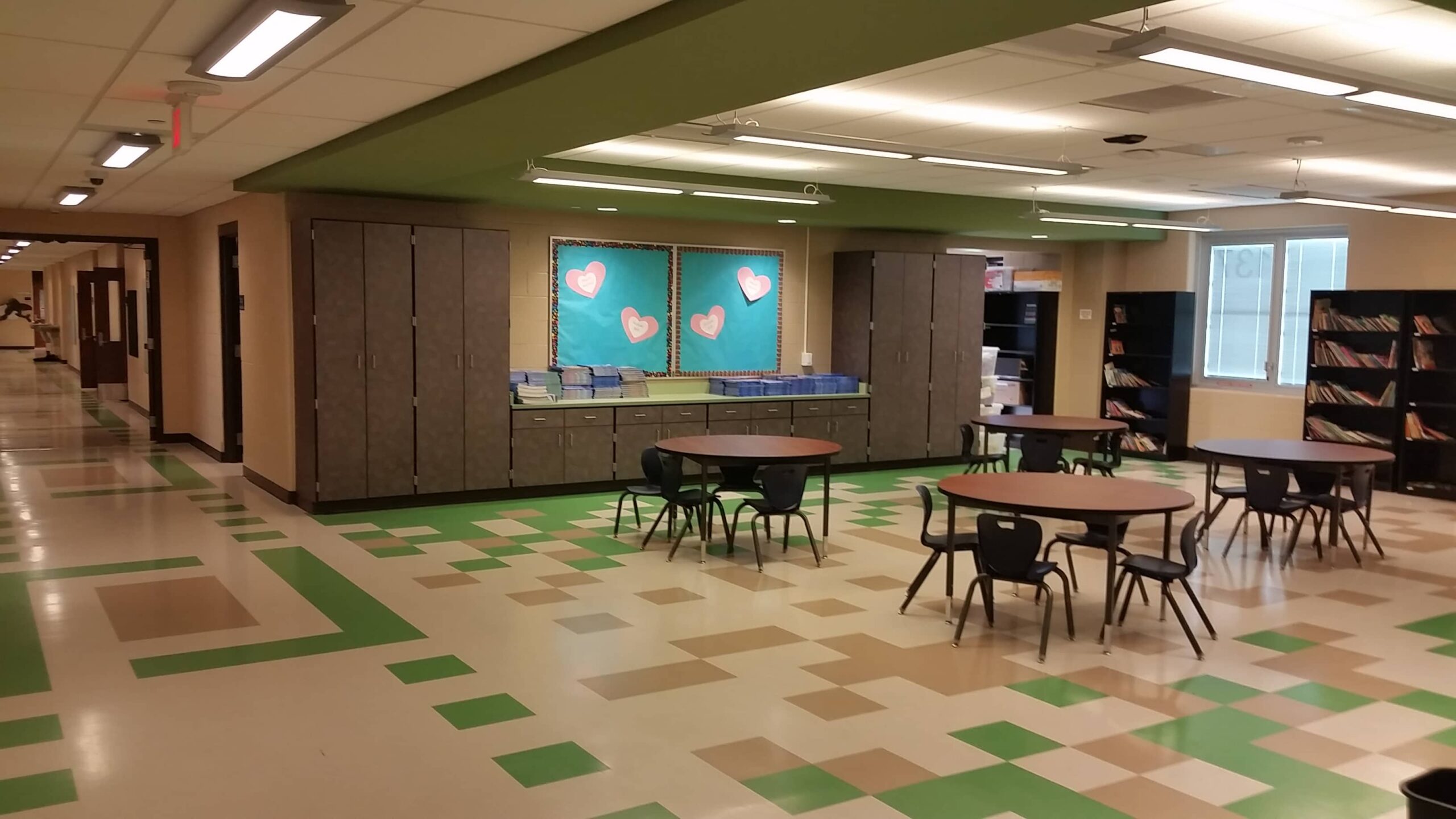 Streetsboro Elementary School Corridor with bookshelves, storage cabinets & tables with chairs