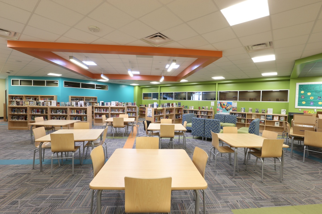 Streetsboro Elementary School Media Center filled with group tables, lounge furniture and bookshelves